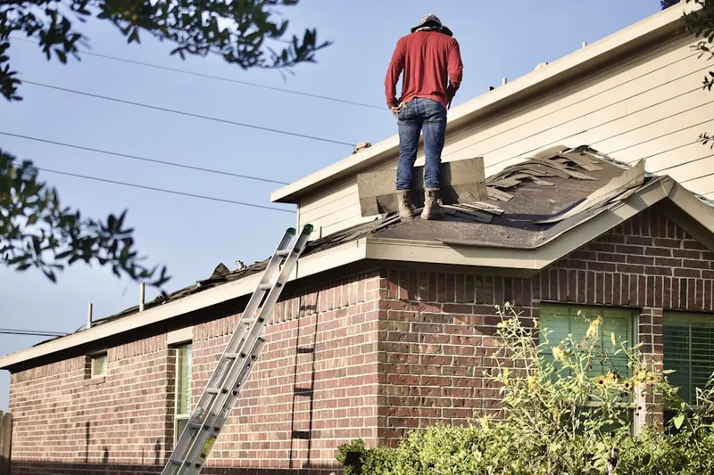 Professional roofer working on a residential roof in North Lake Waco